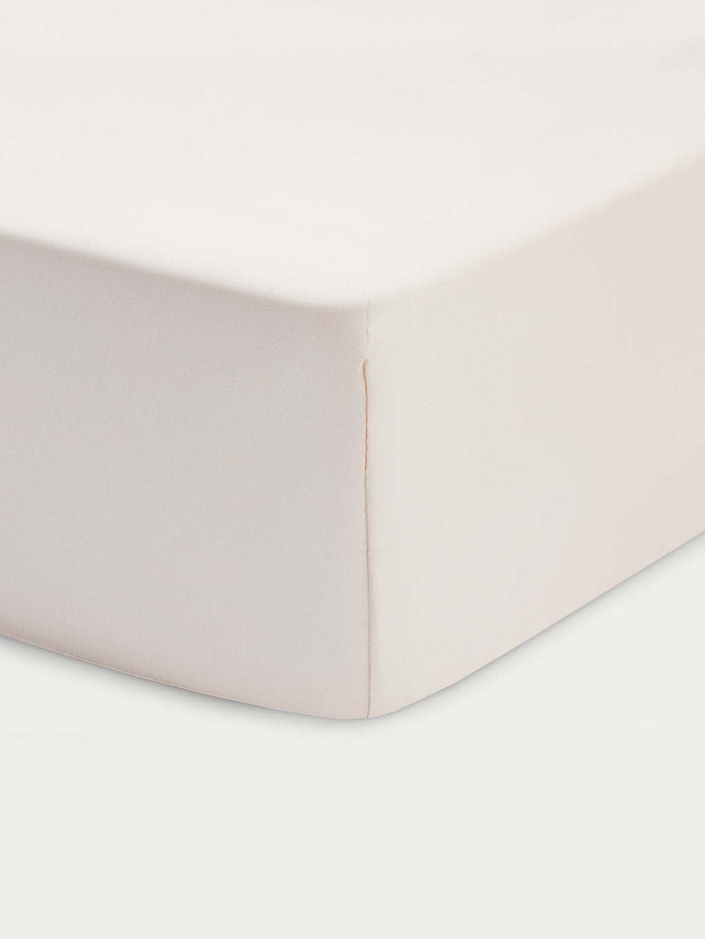 Corner of creme crib sheet with white baackground |Color:Creme