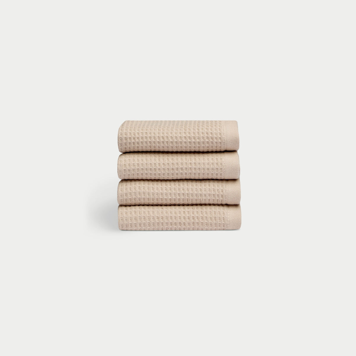 Sand Waffle Wash Cloths neatly folded. The photo was taken with a white background. |Color:Sand
