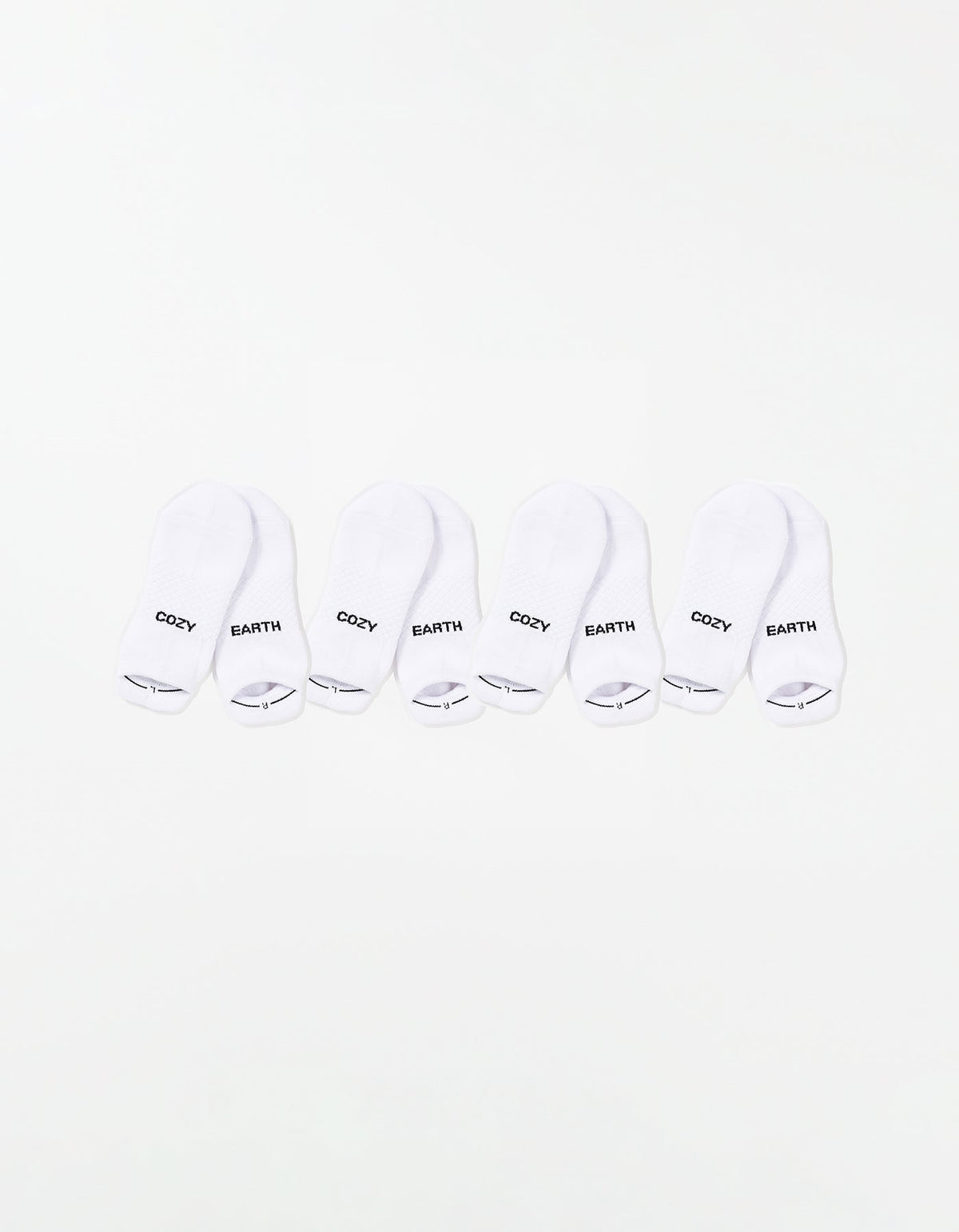 The Essential Ankle Sock 4-Pack by Cozy Earth features four pairs of white ankle socks, each with "COZY" and "EARTH" printed in black on top, arranged in a row on a white background. |Color:White