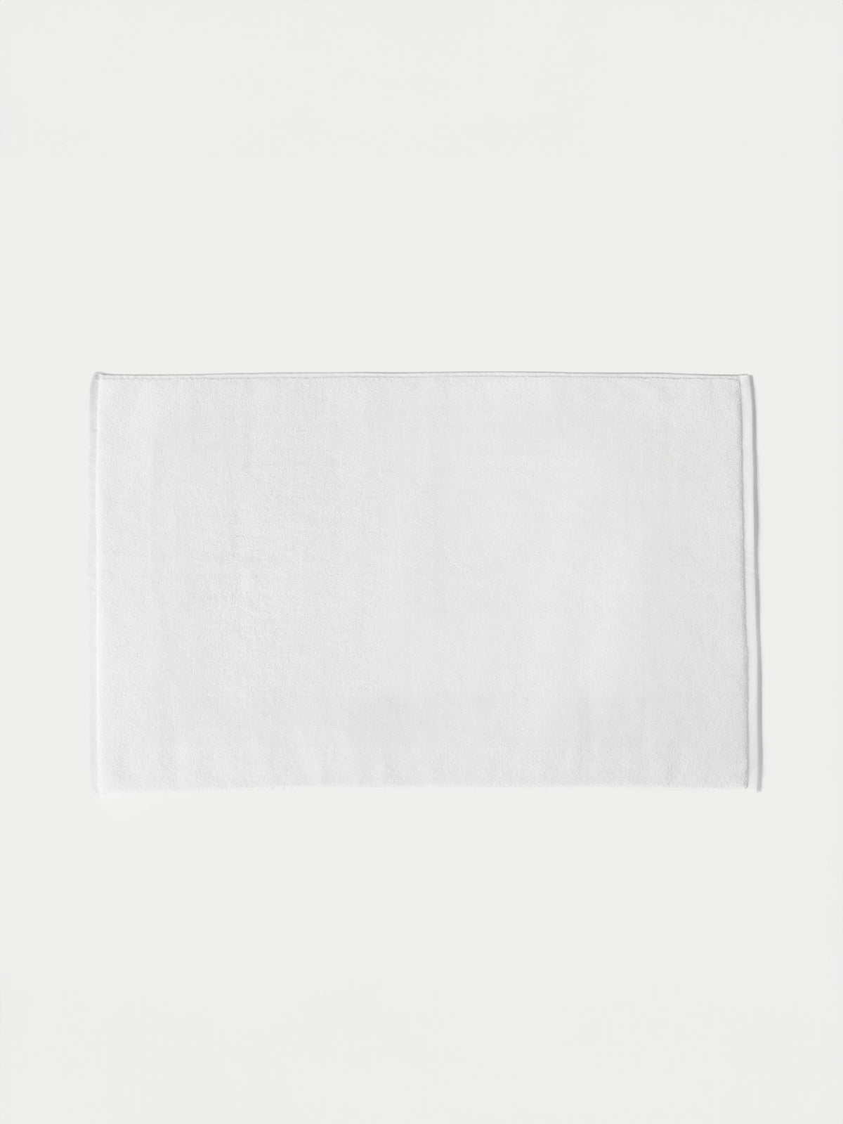 The Cozy Earth Loop Terry Bath Mat, featuring a plain white rectangular design, is displayed on a white background.|Color:White