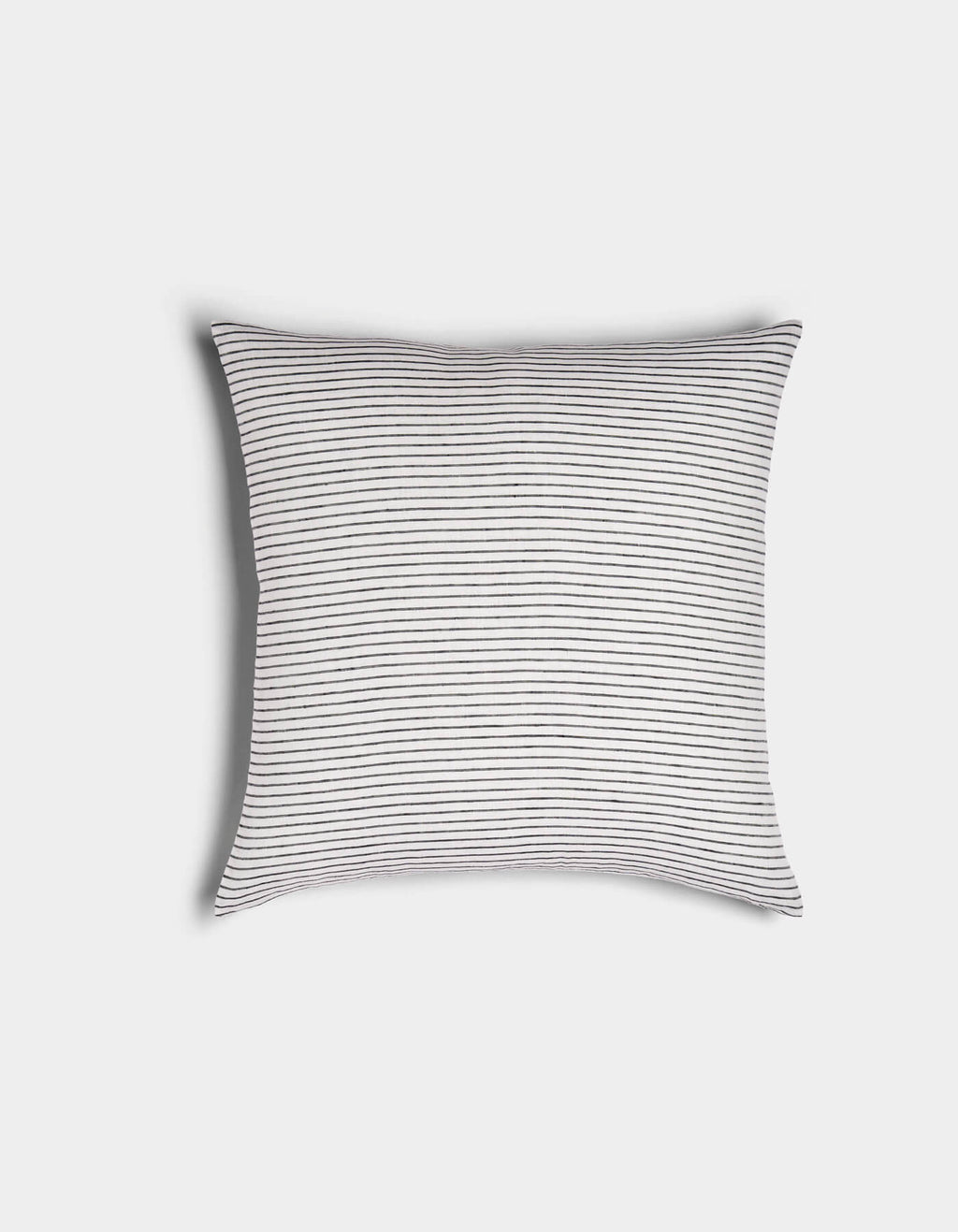 The Cozy Earth Striped Throw Pillow features a white background with thin, evenly spaced black horizontal stripes, shown against a plain white surface.|Color:Narrow Stripe Eclipse and Sea Salt |Size:20" x 20"