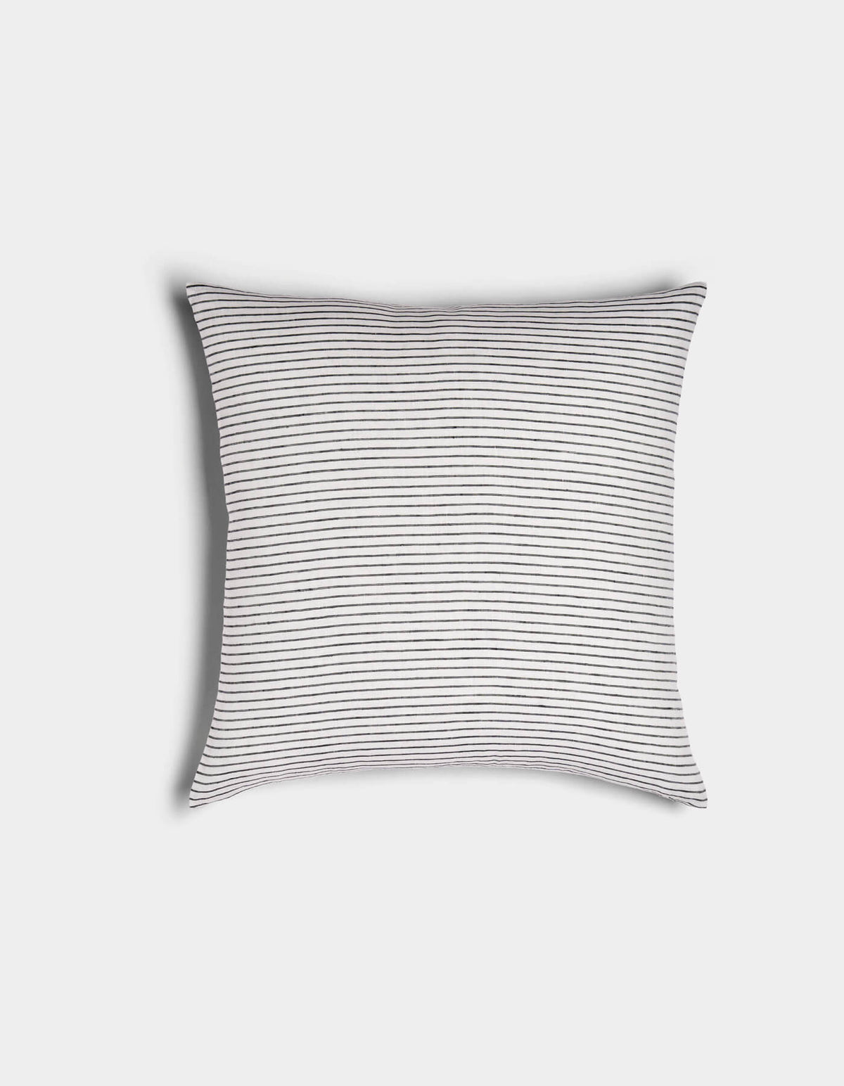 The Cozy Earth Striped Throw Pillow features a white background with thin, evenly spaced black horizontal stripes, shown against a plain white surface.|Color:Narrow Stripe Eclipse and Sea Salt |Size:20" x 20"