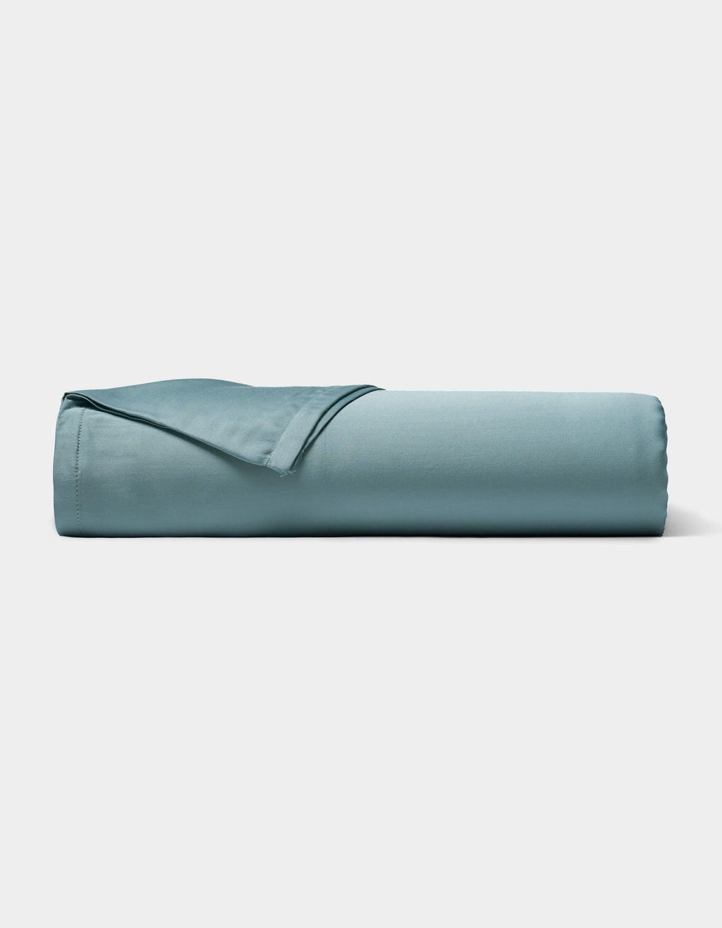 A neatly rolled Bamboo Sheet Set by Cozy Earth in light blue is displayed on a plain white background.|Color:River