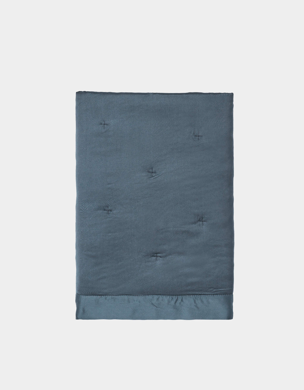 A pair of neatly folded, dark blue Bamboo Quilted Shams by Cozy Earth, featuring a smooth, slightly shiny texture and subtle tufted details, displayed against a plain white background.|Color:Pacific Blue