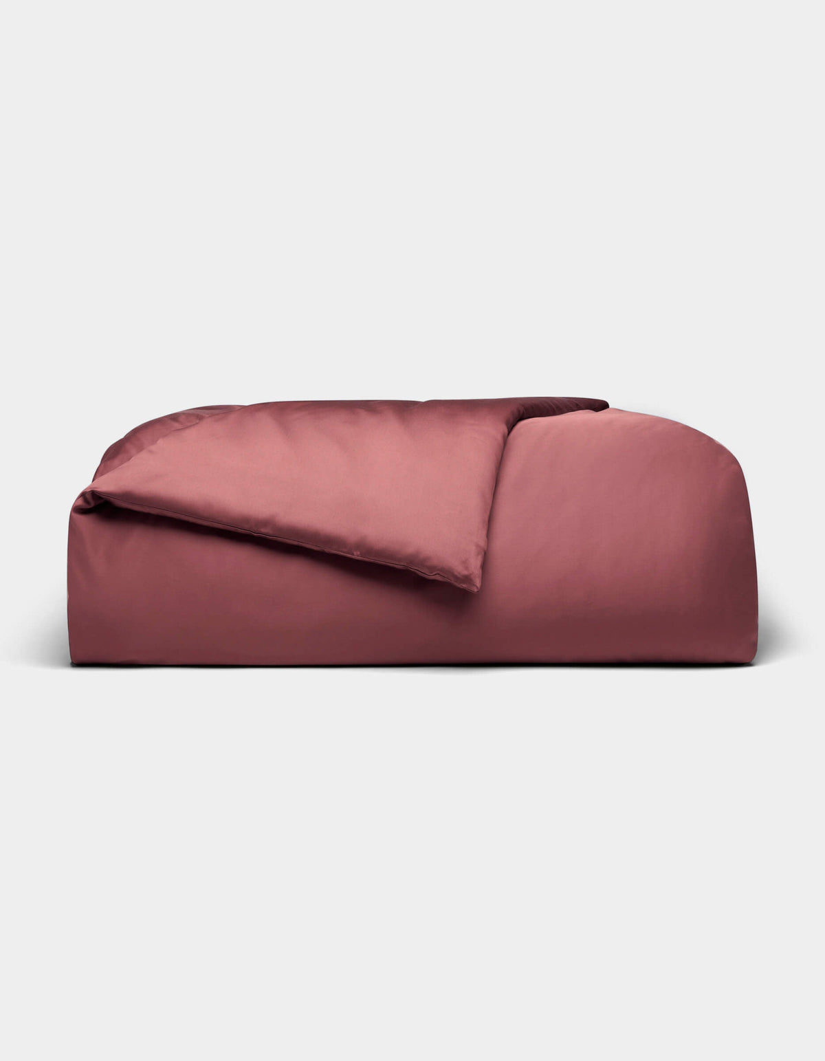 A rectangular, rose-colored Bamboo Duvet Cover from Cozy Earth with a soft, smooth texture and a gentle top fold, displayed against a plain light gray background.|Color:Mulberry