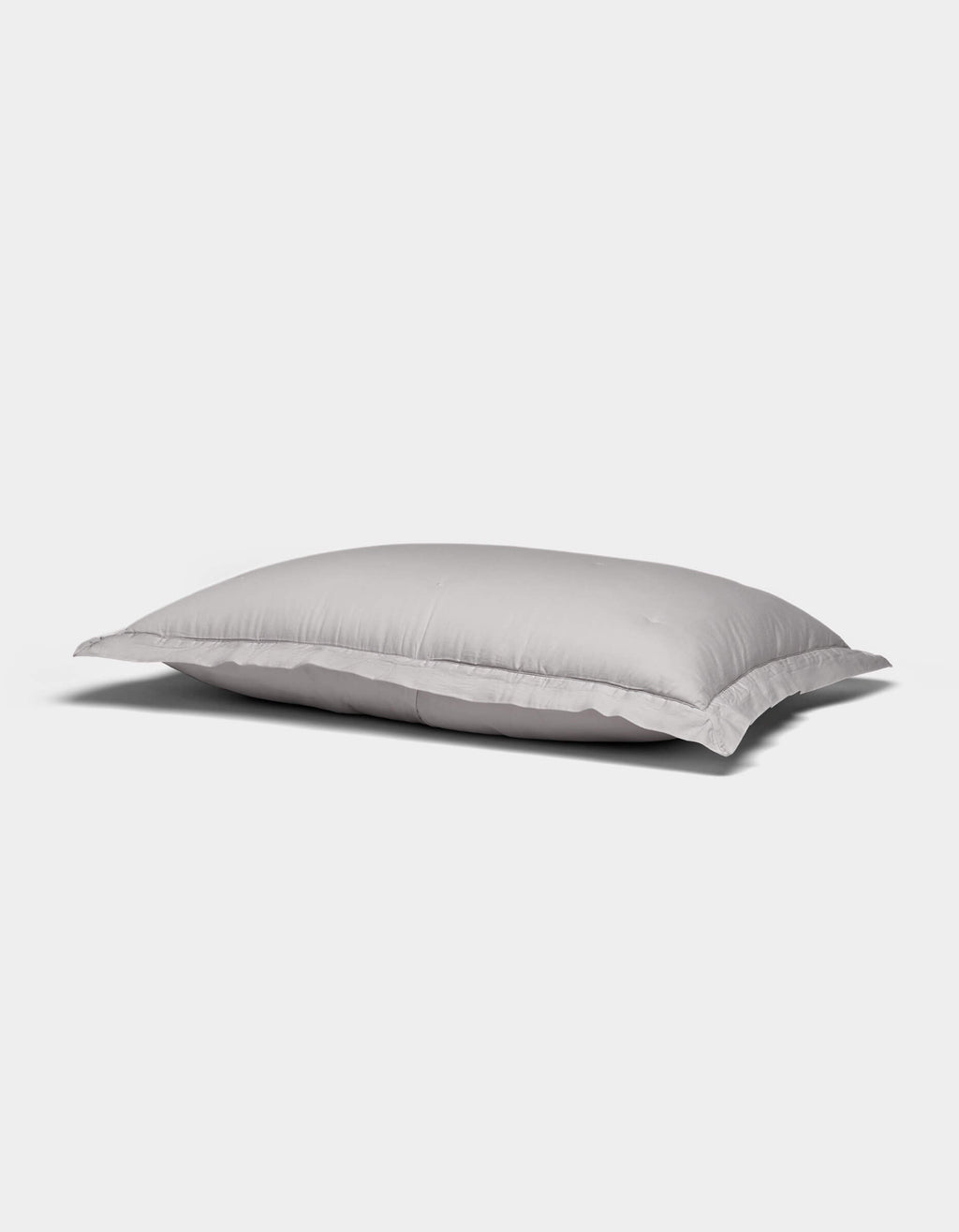 A Soft-Wash Cotton Quilted Sham by Cozy Earth, white and rectangular with a smooth surface, rests on a plain light gray background.|Color:Dew