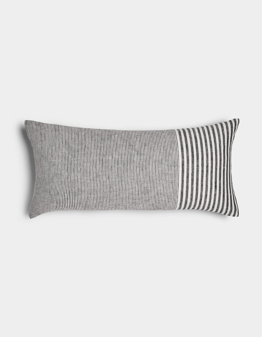 The Cozy Earth Striped Throw Pillow features thin vertical black and white stripes across most of its rectangular surface, with wider stripes at one end, displayed against a plain white background.|Color:Mixed Stripe Eclipse and Sea Salt |Size:14" x 30"