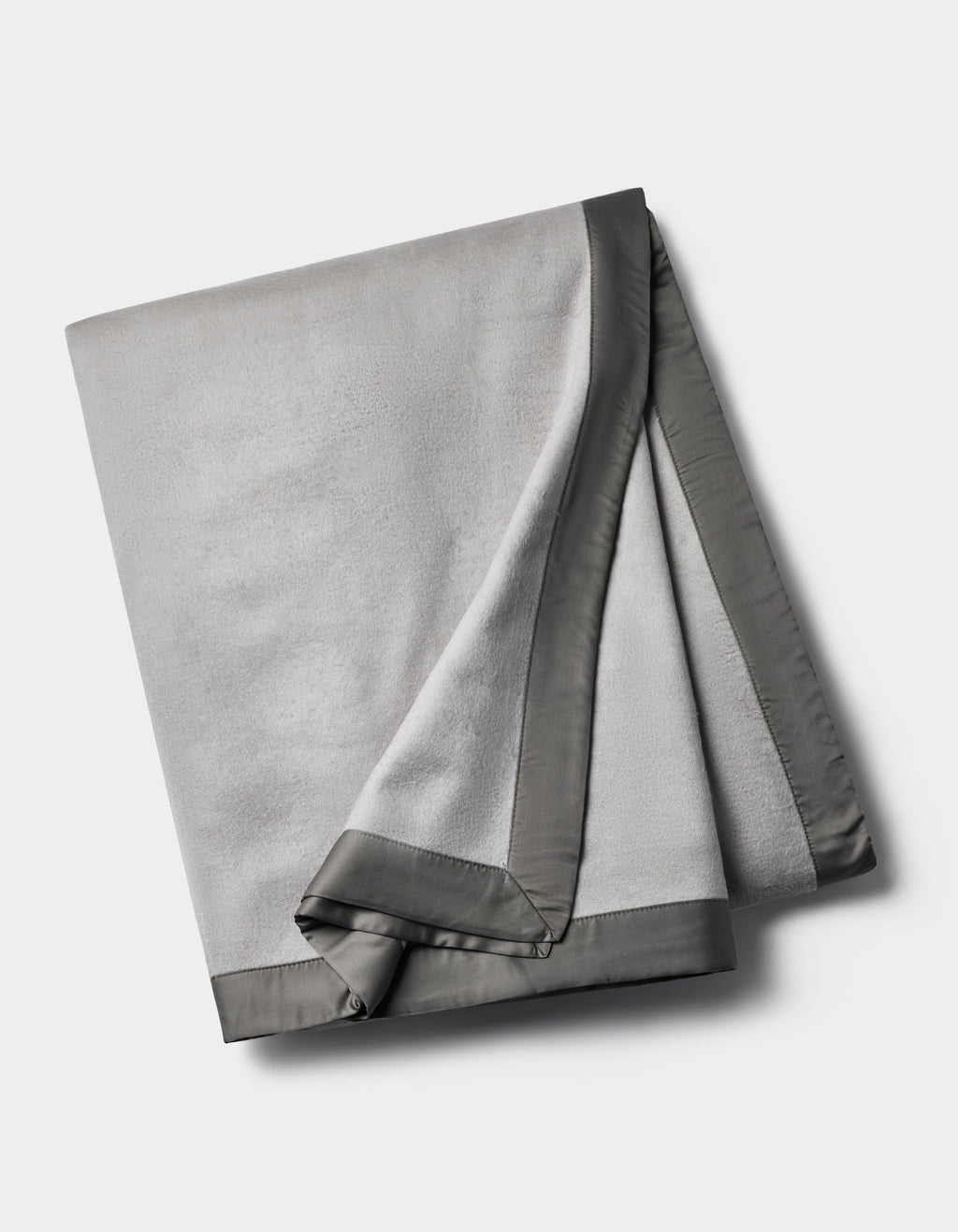 The Cozy Earth Bamboo Blanket is a folded light gray fleece with a smooth, dark gray satin border, shown on a plain white background.|Color:Dove Grey/Charcoal