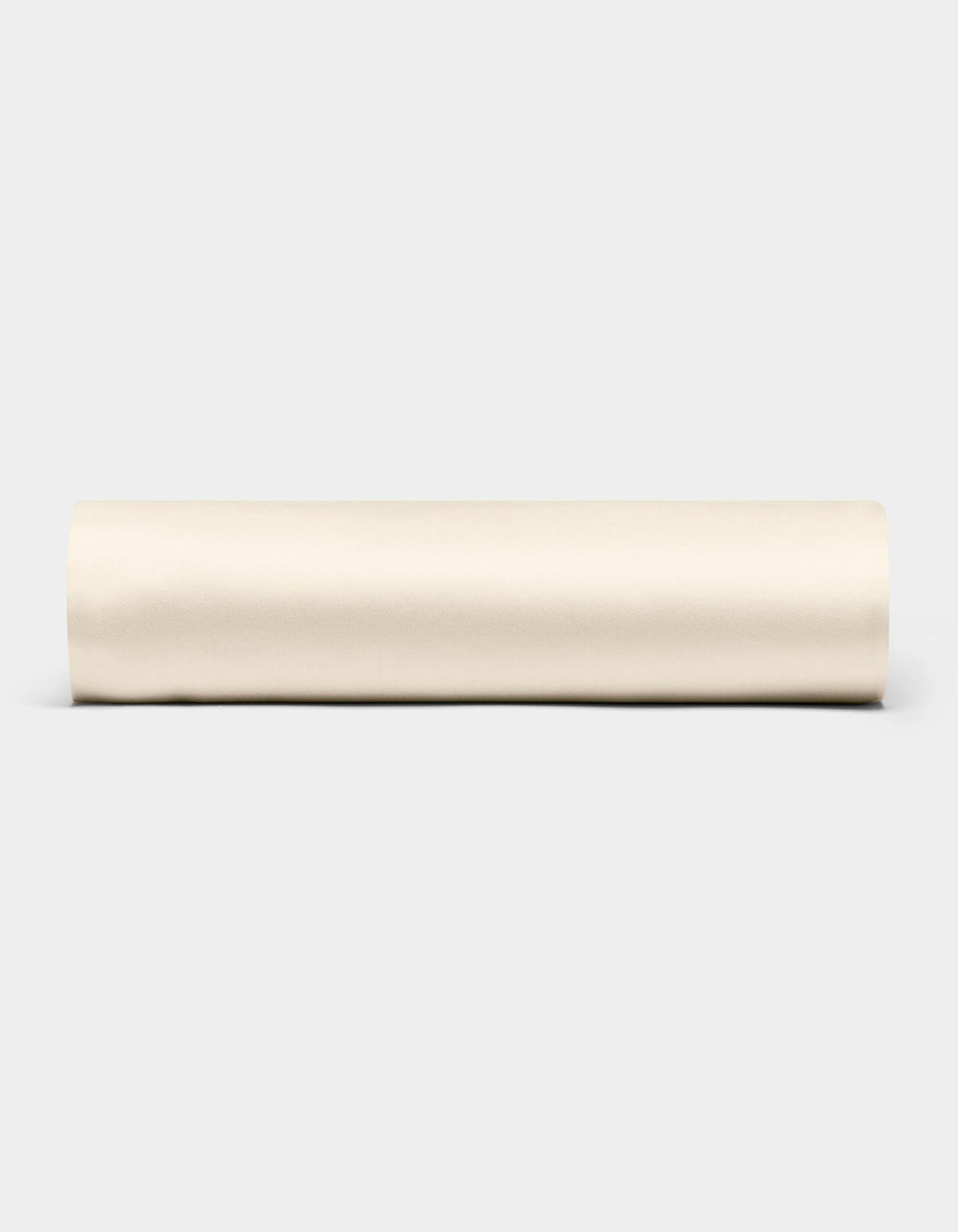 A Bamboo Fitted Sheet by Cozy Earth is displayed horizontally against a plain light gray background.|Color:Creme