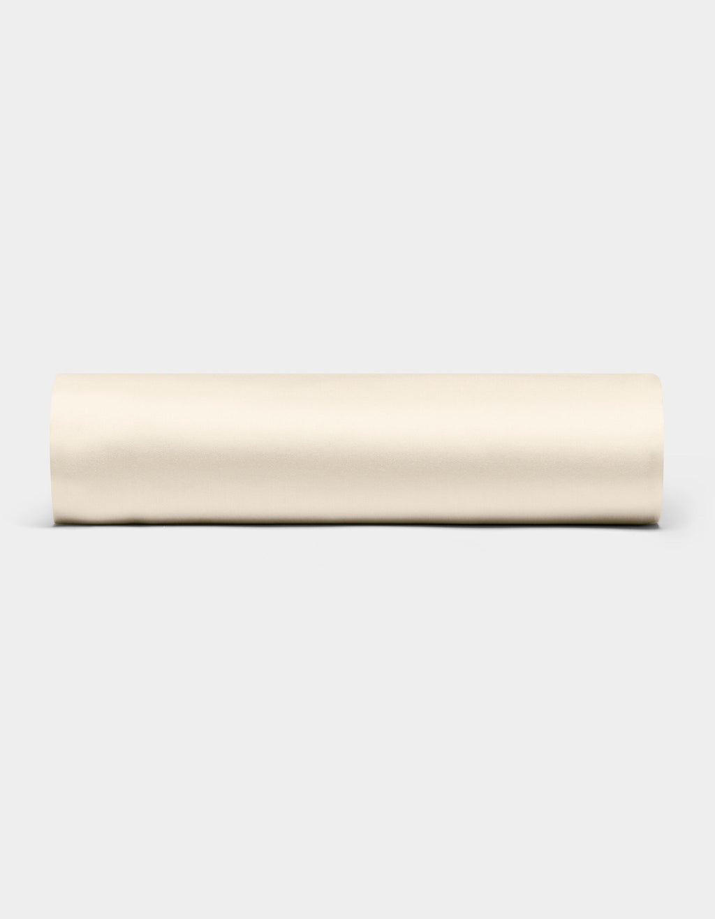 A Bamboo Fitted Sheet by Cozy Earth is displayed horizontally against a plain light gray background.|Color:Creme
