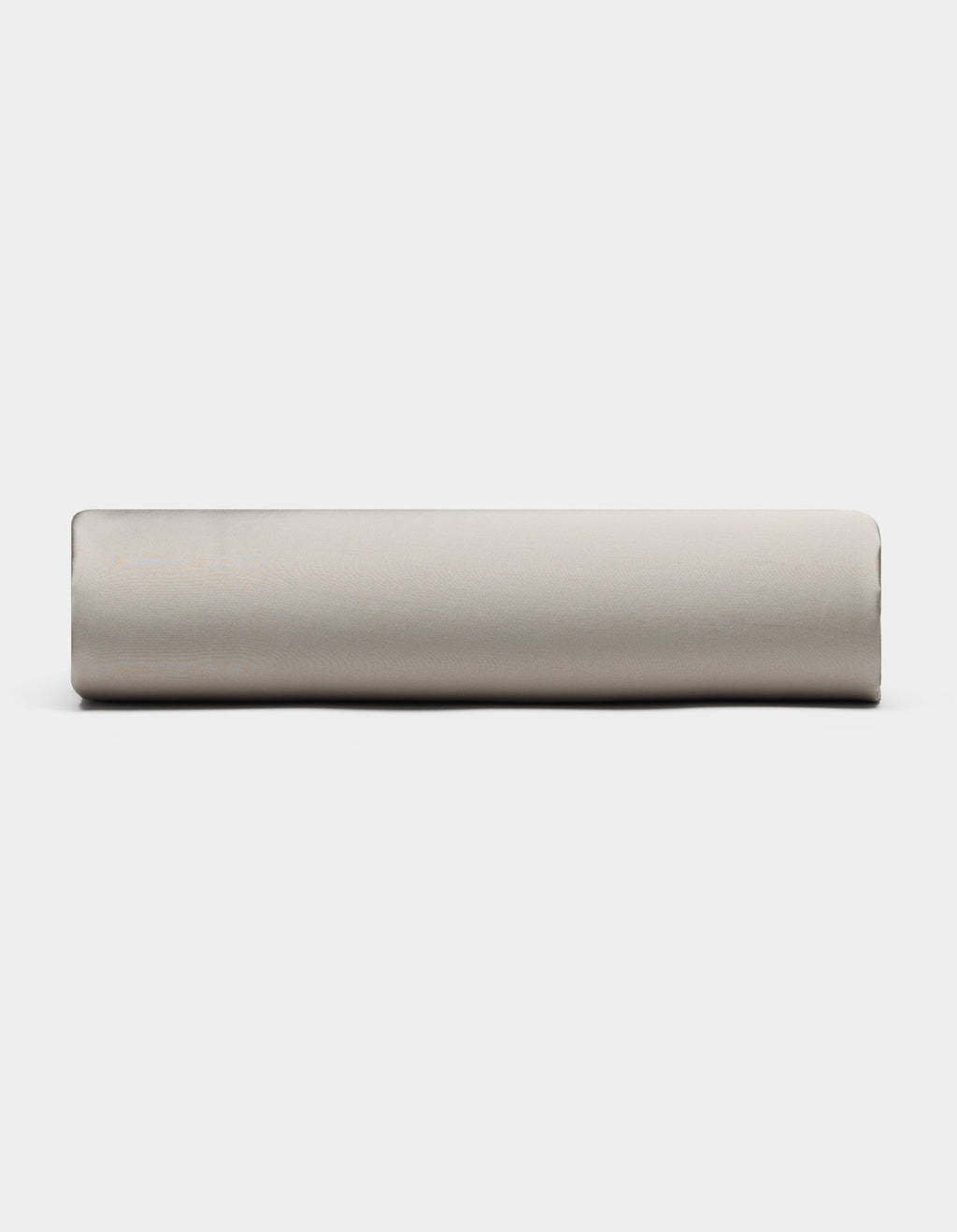 A Bamboo Fitted Sheet by Cozy Earth, in light gray, is rolled up and placed horizontally against a plain white background, viewed from the side.|Color:Dove Grey