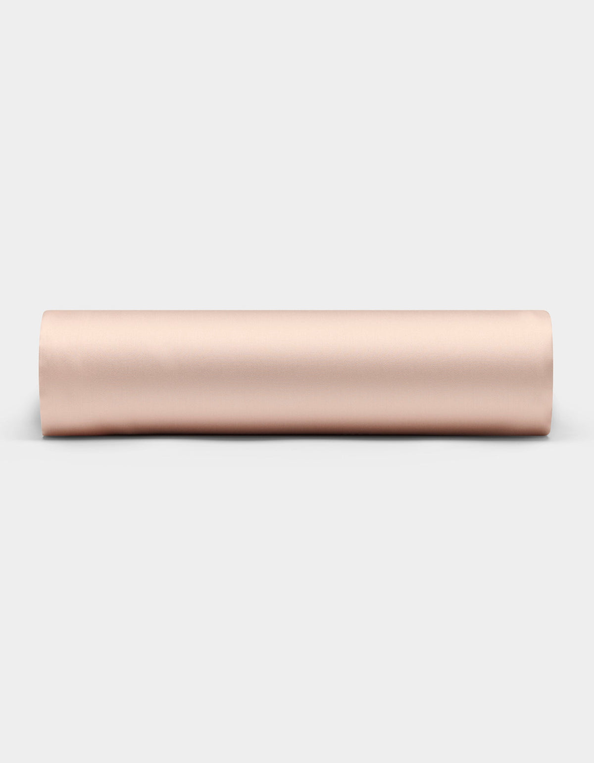 A Cozy Earth Bamboo Fitted Sheet in a light beige shade is shown rolled up on a plain white background, viewed from the side.|Color:Peony