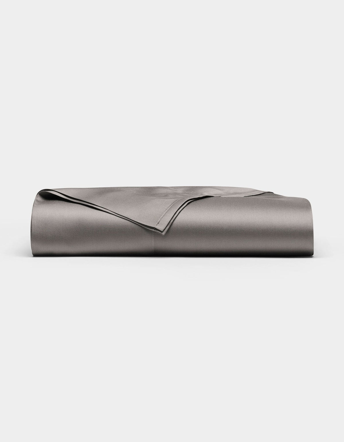A neatly folded, smooth Cozy Earth Bamboo Flat Sheet in grey is displayed against a plain white background.|Color:Charcoal