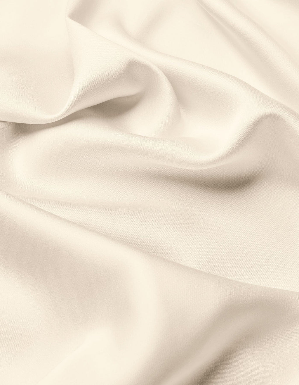 A close-up of the Cozy Earth Bamboo Flat Sheet highlights its smooth, cream-colored fabric with soft folds and gentle shadows, offering a sense of texture and elegance.|Color:Creme