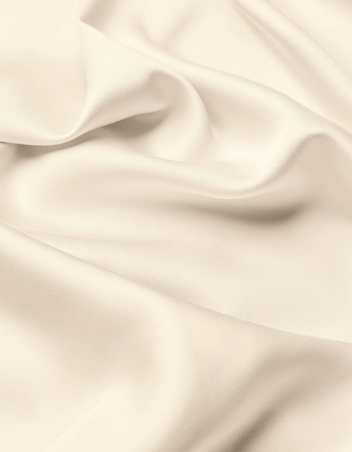 A close-up of the Cozy Earth Bamboo Flat Sheet highlights its smooth, cream-colored fabric with soft folds and gentle shadows, offering a sense of texture and elegance.|Color:Creme