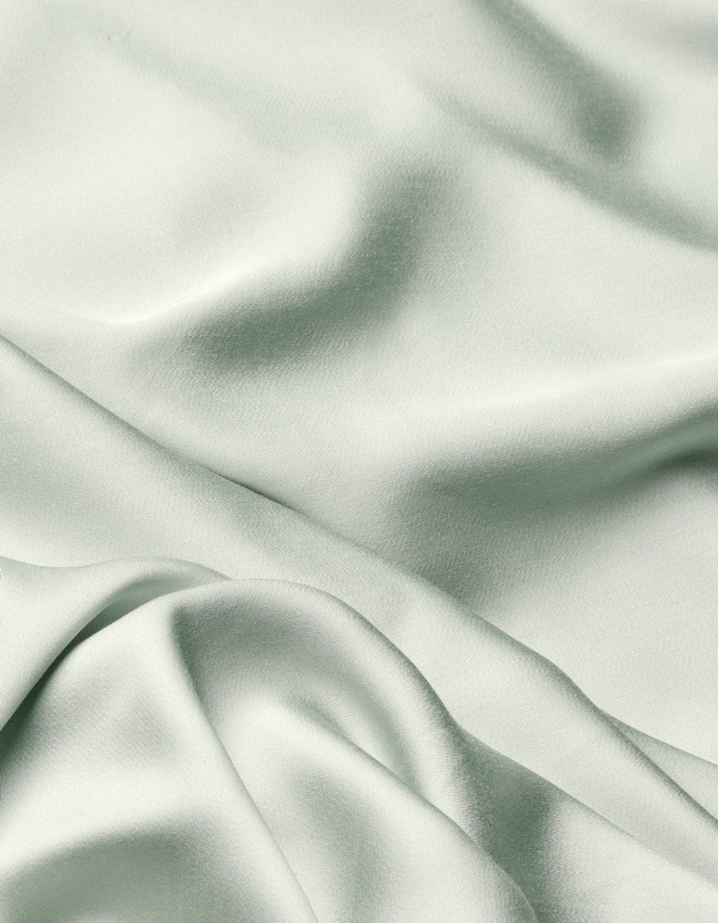 The Cozy Earth Bamboo Flat Sheet features a soft, light sage green fabric with a smooth texture and gentle folds that create subtle shadows and highlights across its surface.|Color:Laurel