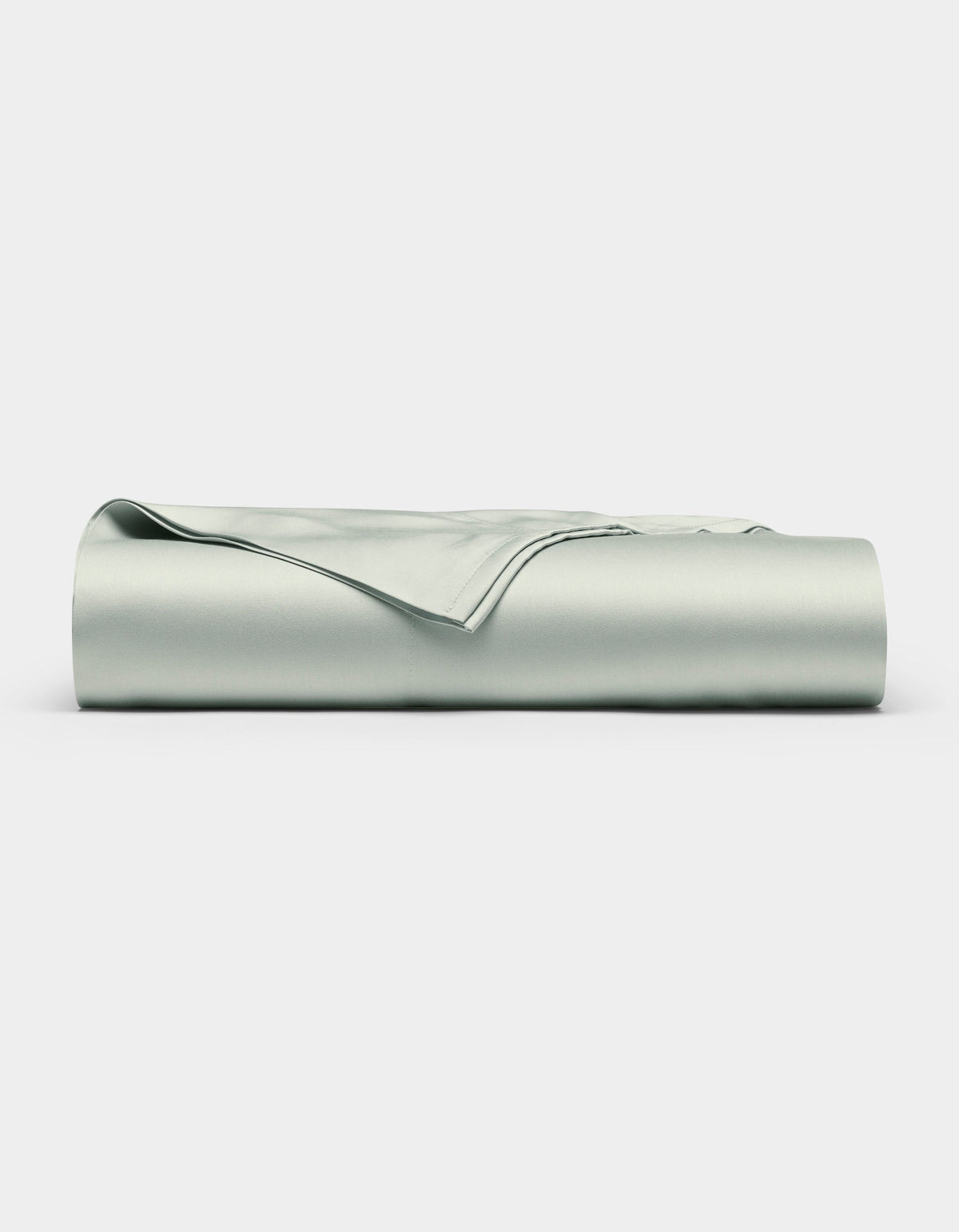 A neatly folded Bamboo Flat Sheet by Cozy Earth in light gray is displayed against a plain white background.|Color:Laurel