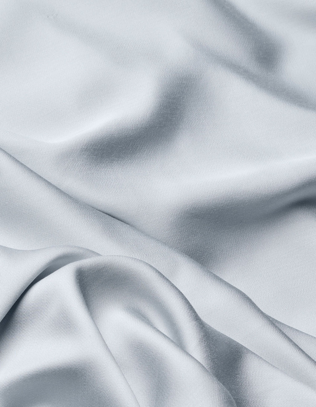 The Cozy Earth Bamboo Flat Sheet in light gray features a silky, smooth texture with soft folds and gentle shadows, adding movement and elegance to your bedding.|Color:Shore