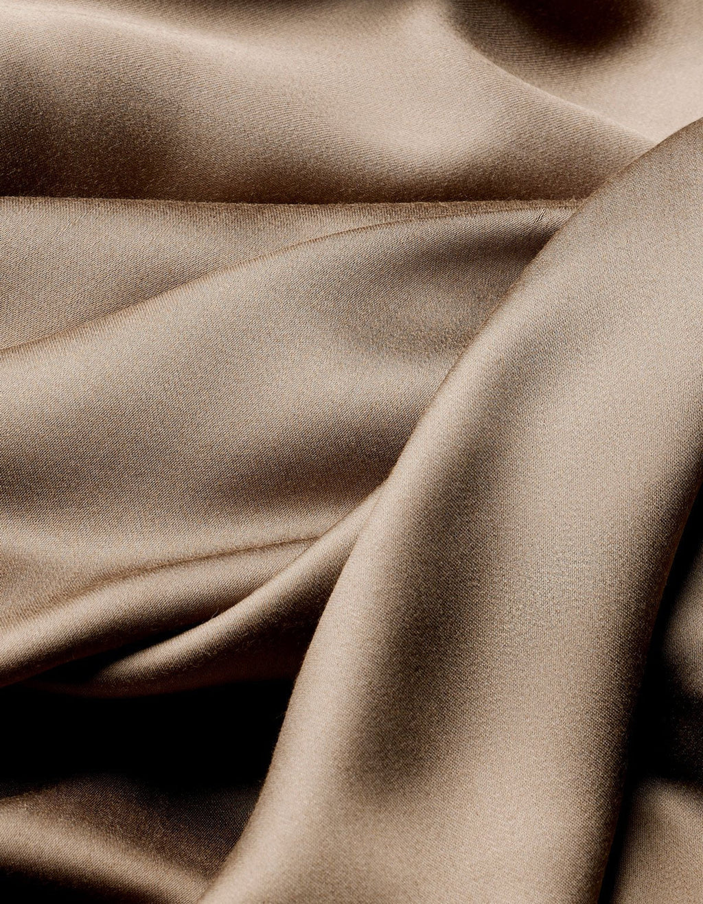The Cozy Earth Bamboo Flat Sheet features smooth, light brown satin fabric with soft folds and gentle curves for a shimmering, luxurious texture.|Color:Walnut