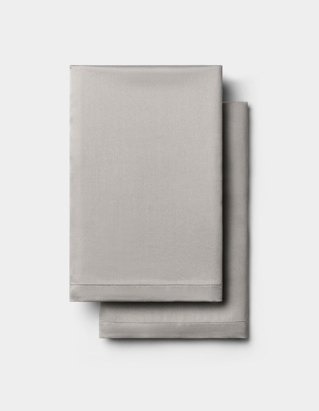 Two neatly folded light gray Cozy Earth Bamboo Pillowcases stacked on a plain white background.|Color:Light Grey