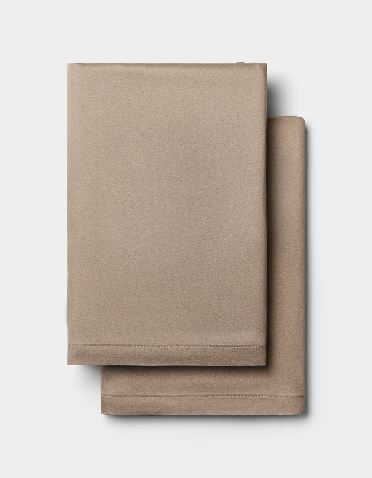 Two neatly folded Cozy Earth Bamboo Pillowcases are stacked on a plain white background.|Color:Walnut