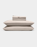 A neatly stacked Cozy Earth Bamboo Sheet Set, featuring two pillows, a folded fitted sheet, flat sheet, and pillowcases, displayed against a plain white background.|Color:Driftwood