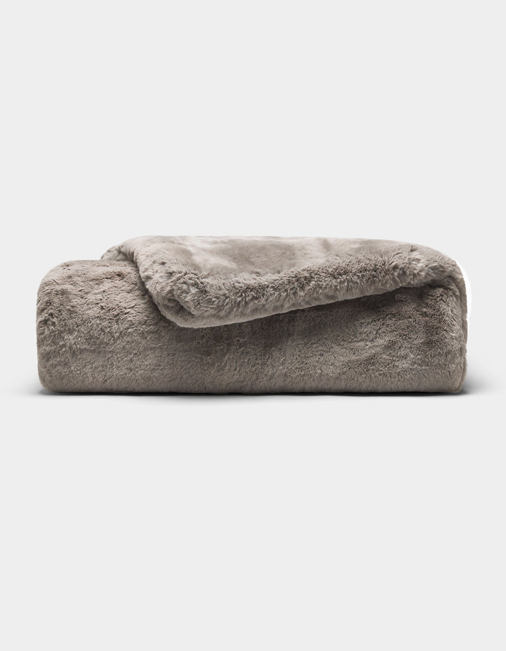 The Cozy Earth Cuddle Blanket, a soft gray faux fur throw, is neatly folded against a plain white background.|Color:Dove Grey
