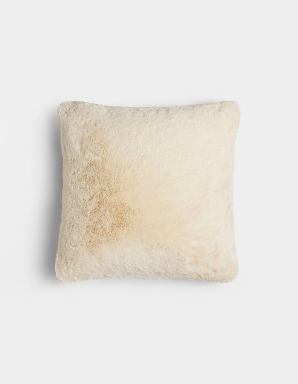 The Cozy Earth Cuddle Pillow is a square, fluffy, cream-colored pillow with a subtle light brown stain on one side, shown against a plain white background.|Color:Creme |Size:20" x 20"