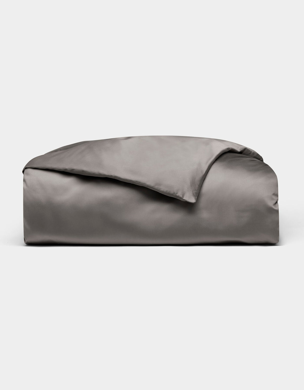 A neatly folded, shiny gray Bamboo Duvet Cover by Cozy Earth is displayed on a plain white background.|Color:Charcoal