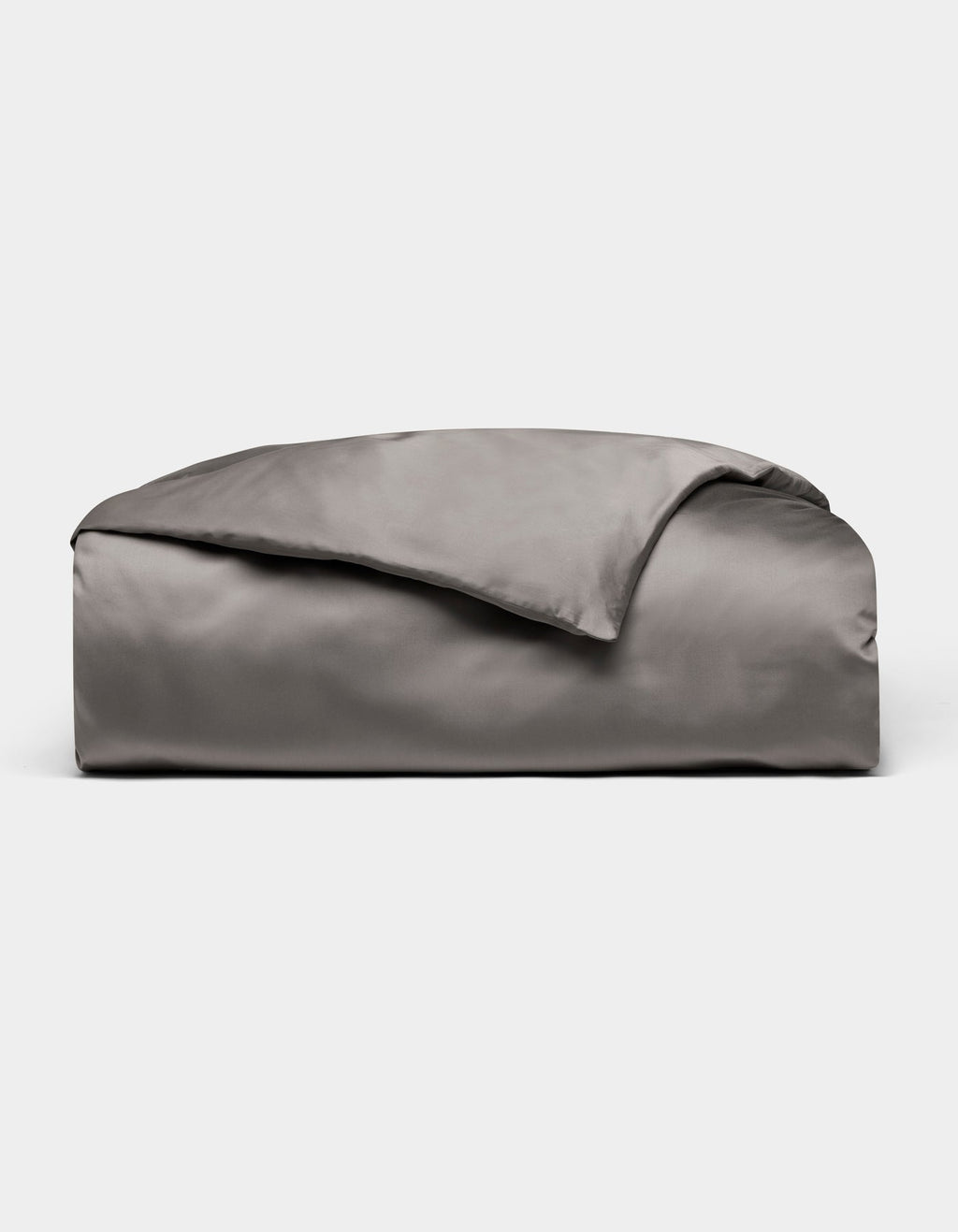 A neatly folded, shiny gray Bamboo Duvet Cover by Cozy Earth is displayed on a plain white background.|Color:Charcoal