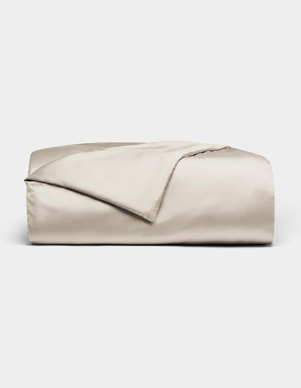 The Bamboo Duvet Cover by Cozy Earth, in light beige with a smooth satin finish, is neatly folded and displayed against a plain white background.|Color:Oat