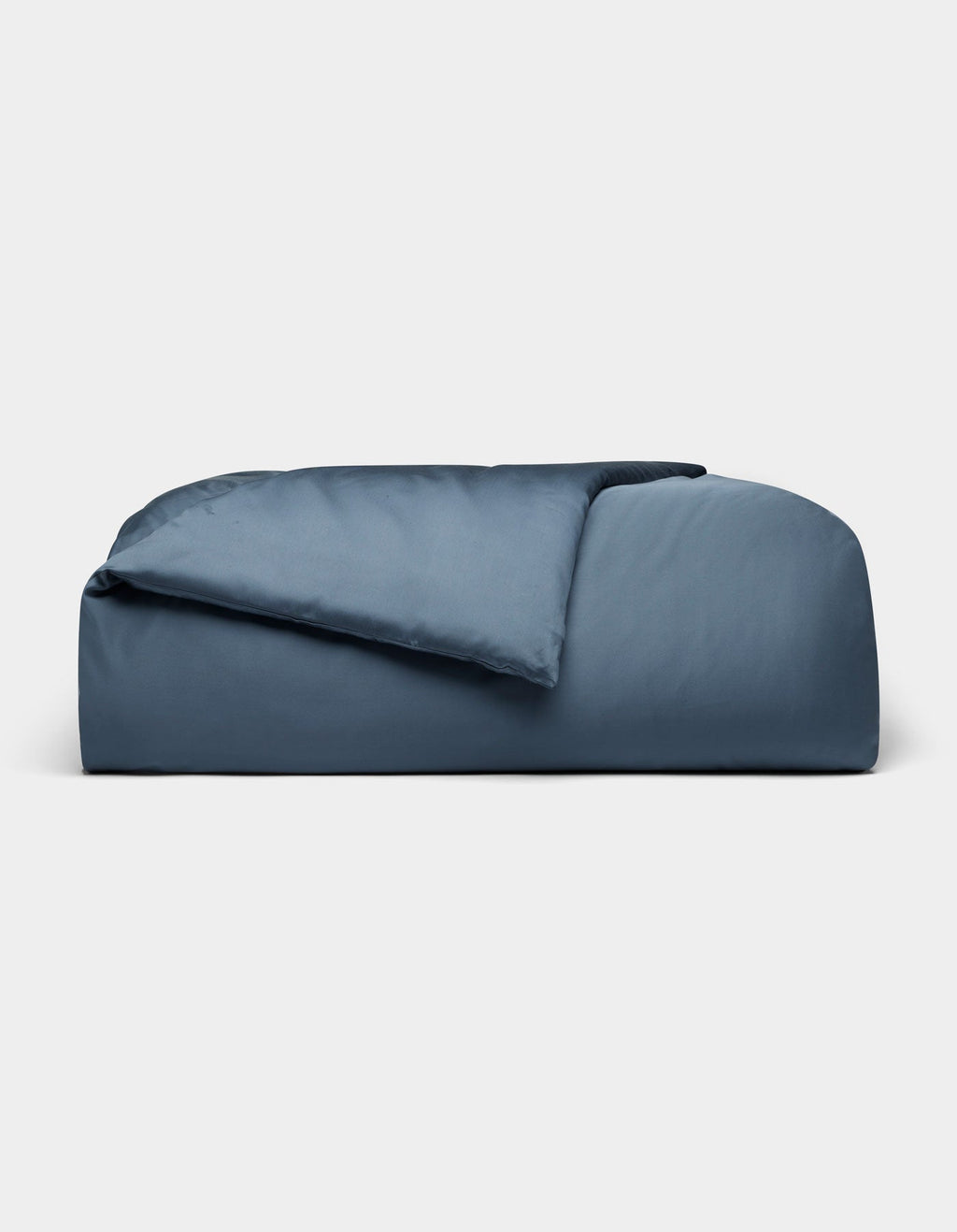 The Cozy Earth Bamboo Duvet Cover, in dark blue and rectangular shape, features plush fabric with a partially folded comforter, displayed against a plain light gray background.|Color:Pacific Blue