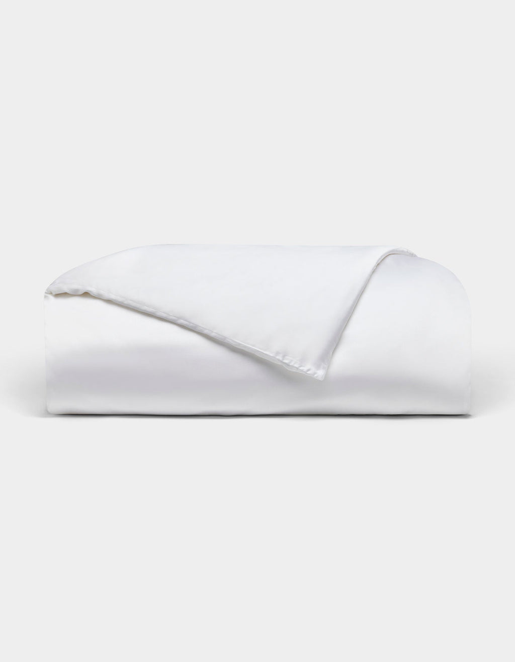 The Bamboo Duvet Cover by Cozy Earth is neatly folded with one corner flipped over, showcased against a plain light background.|Color:White