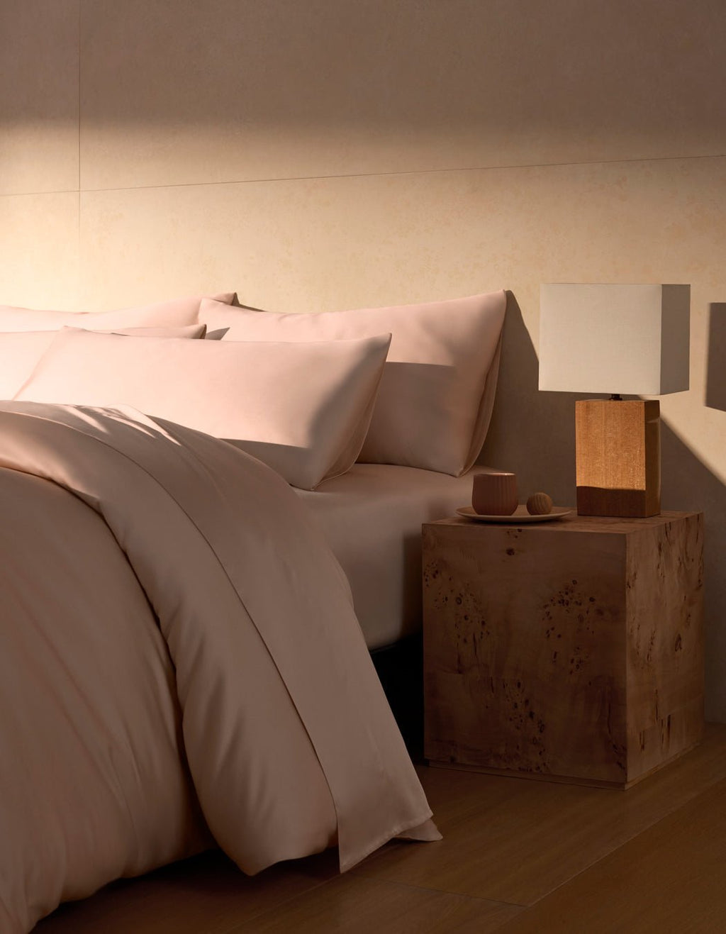 A Bamboo Duvet Cover by Cozy Earth in peony covers a cozy bed with pillows. |Color:Peony