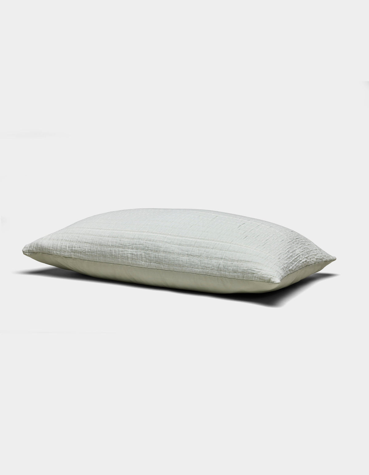 The Baja Matelasse Sham by Cozy Earth is a light-colored, rectangular pillow sham with a soft, textured surface. Displayed against a white background, it looks plush and comfortable.|Color:Bone/Laurel