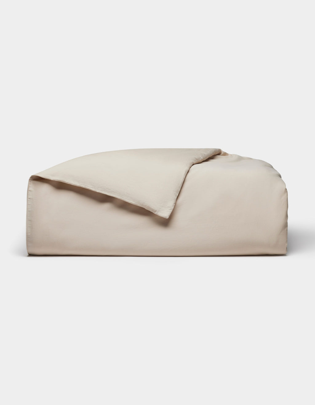 The Cozy Earth Soft-Wash Cotton Duvet Cover, in light beige, is neatly folded with one corner partially flipped over and displayed against a plain white background.|Color:Driftwood