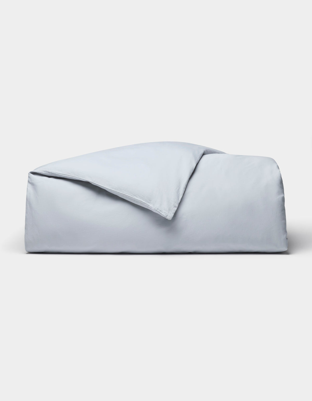 The Cozy Earth Soft-Wash Cotton Duvet Cover set, in light blue, is neatly folded and displayed against a plain white background.|Color:Shore