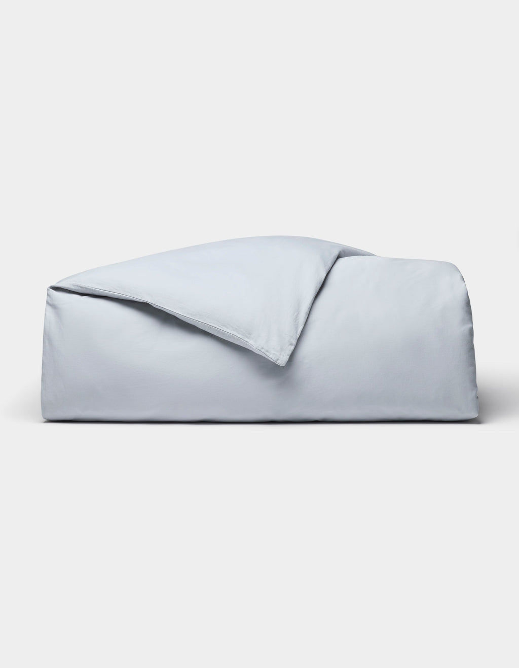 The Cozy Earth Soft-Wash Cotton Duvet Cover set, in light blue, is neatly folded and displayed against a plain white background.|Color:Shore