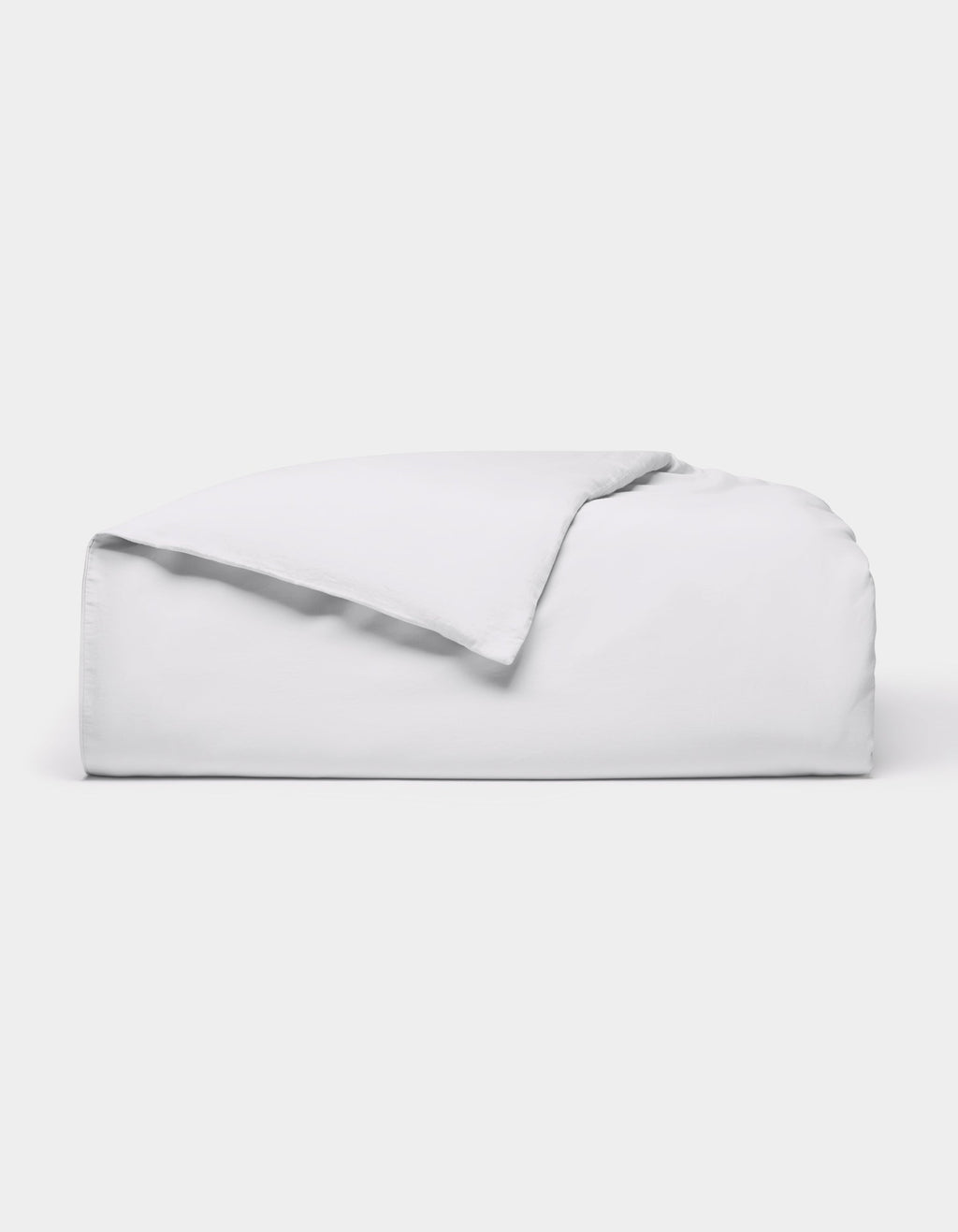 The Cozy Earth Soft-Wash Cotton Duvet Cover, in white, is neatly folded on a white background with one corner flipped over to show the inside.|Color:White
