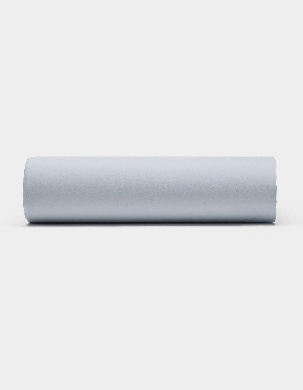 A Soft-Wash Cotton Sheet Set by Cozy Earth is displayed on a plain white background, featuring smooth, light gray fabric arranged neatly to showcase its soft texture.|Color:Shore