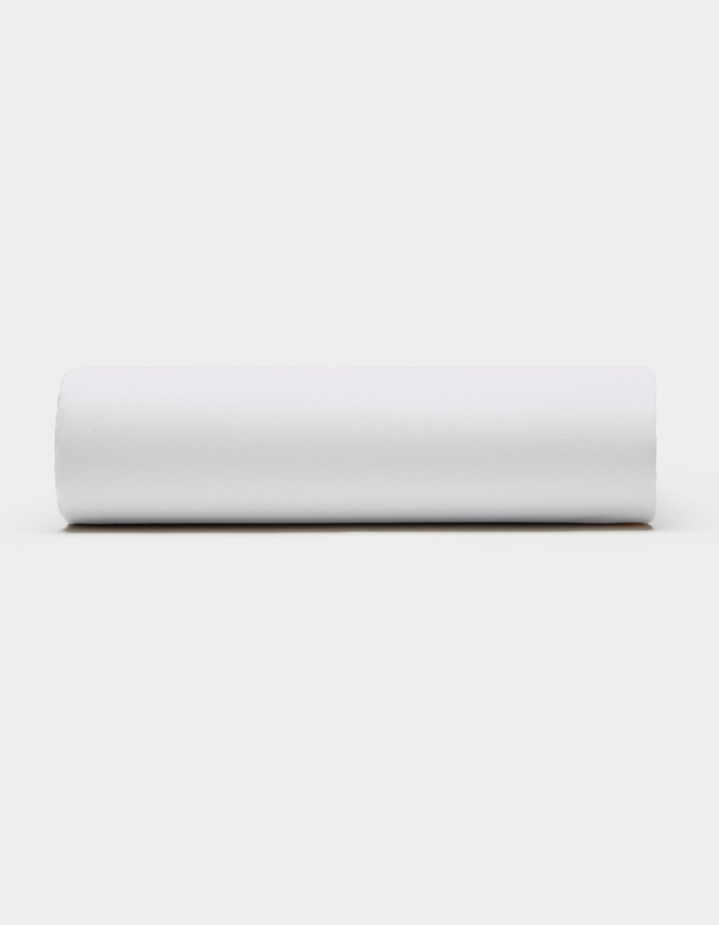 A Soft-Wash Cotton Fitted Sheet by Cozy Earth, in plain white, is displayed horizontally against a light gray background, viewed from the side.|Color:White
