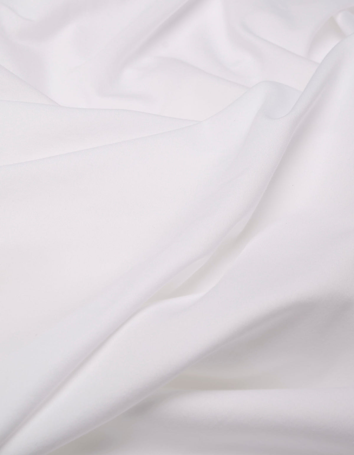 A close-up of the Cozy Earth Soft-Wash Cotton Duvet Bundle shows its soft, white fabric with gentle folds and a smooth texture, creating a calm and clean appearance.|Color:White