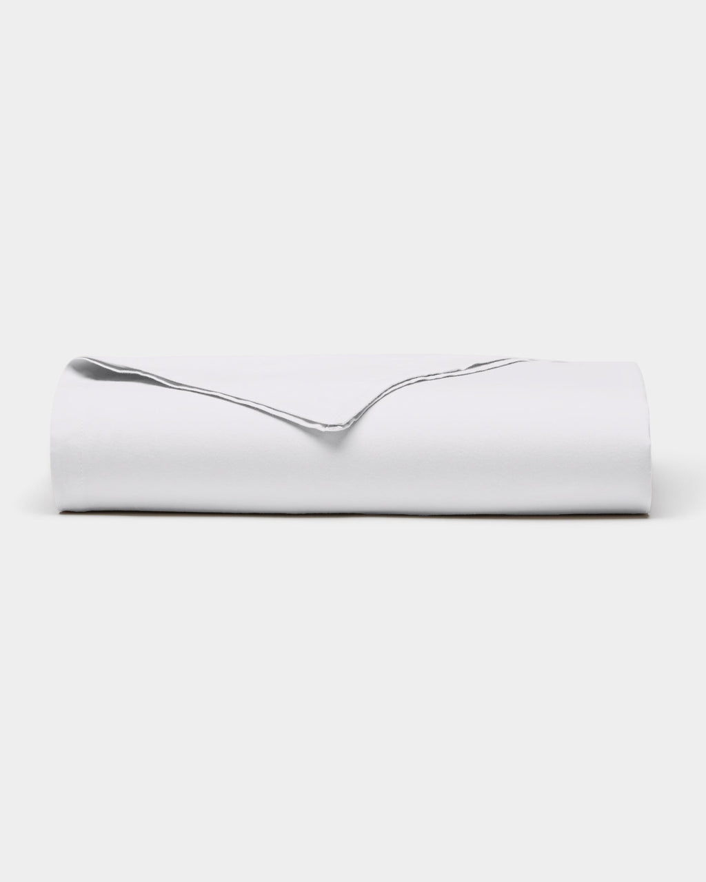 A neatly folded Soft-Wash Cotton Sheet Set by Cozy Earth, featuring a visible edge, is placed on a plain white background.|Color:White