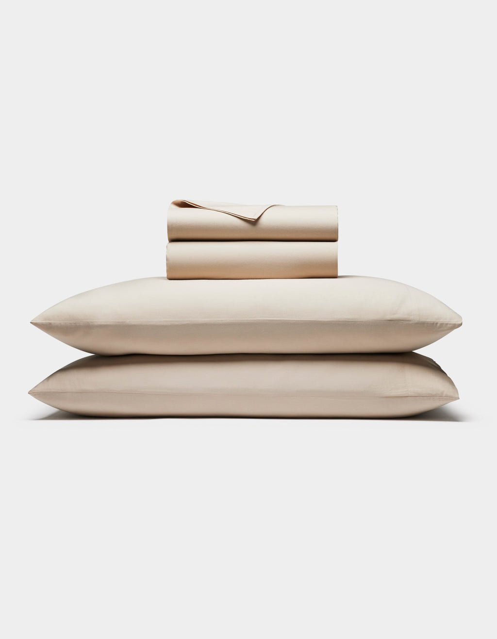 The Cozy Earth Soft-Wash Cotton Sheet Set is neatly folded with two stacked pillows at the bottom and matching sheets and pillowcases on top, all displayed against a plain white background.|Color:Driftwood