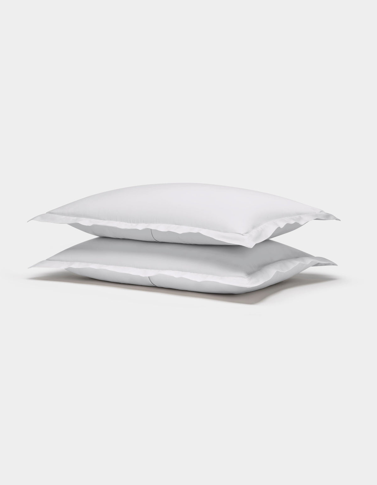 Two Cozy Earth Soft-Wash Cotton Shams are stacked neatly on top of each other against a plain white background.|Color:White