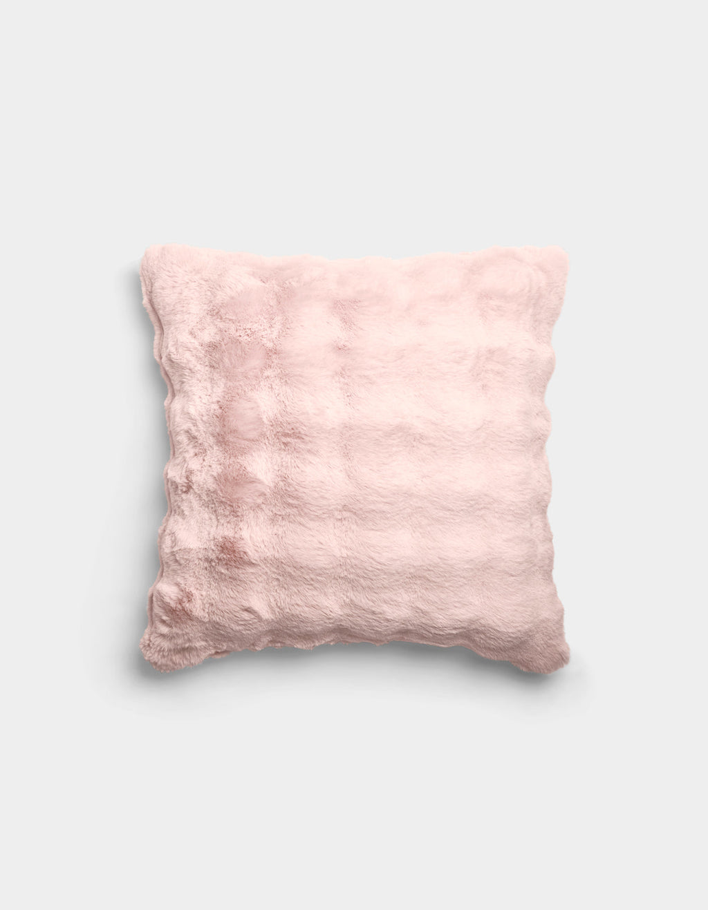 The Bubble Cuddle Pillow by Cozy Earth is a square, pale pink plush pillow with a soft, fuzzy texture and subtle horizontal ridges, shown against a plain light gray background.|Color:Blossom |Size:20" x 20"