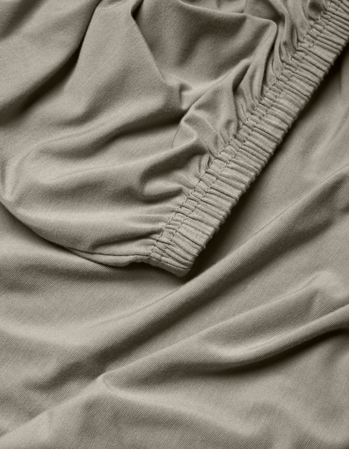 A close-up of the Cozy Earth Bamboo Jersey Fitted Sheet fabric.|Color:Stone
