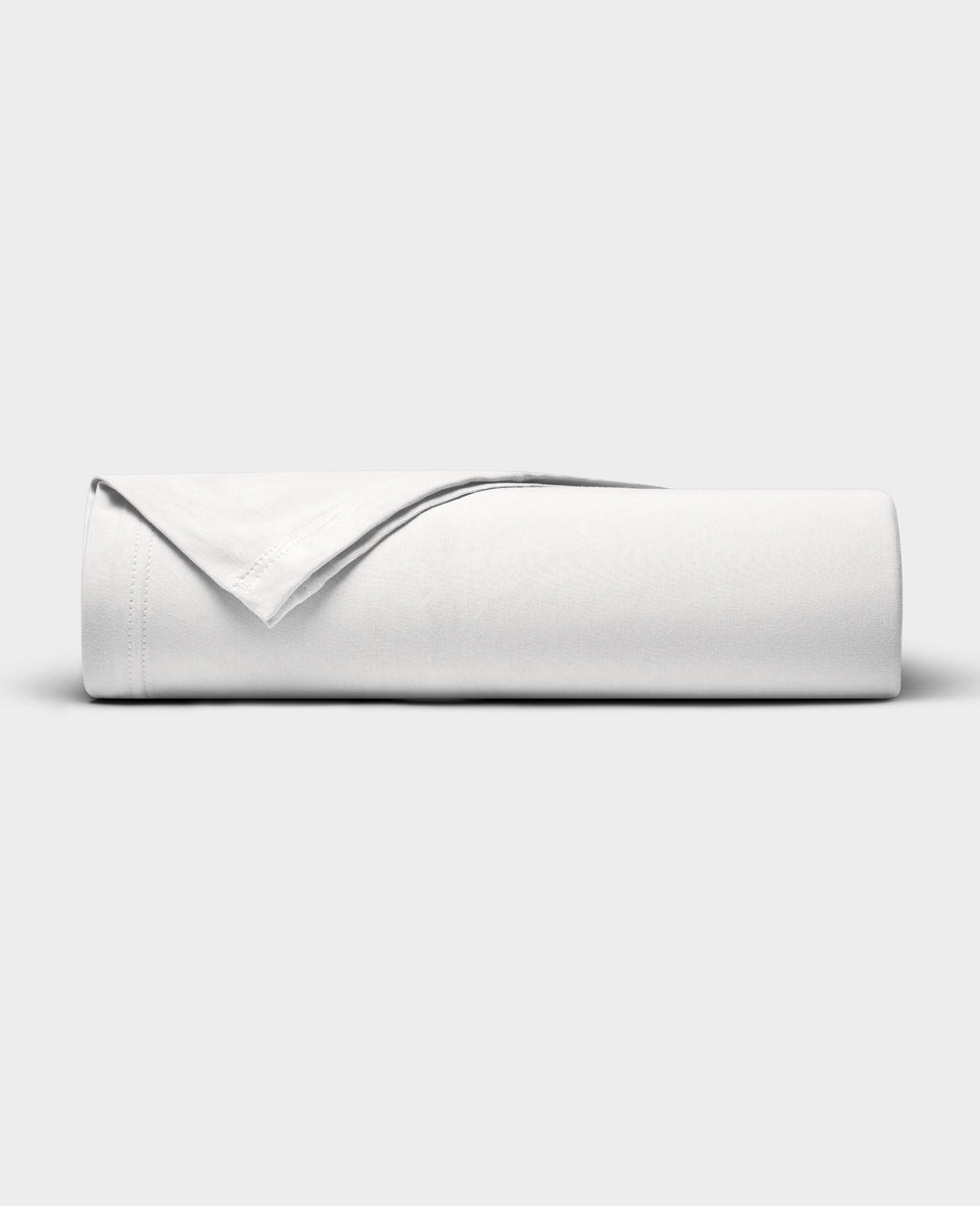The Cozy Earth Bamboo Jersey Flat Sheet is neatly folded with a corner turned back, showcased against a plain light gray background.|Color:White
