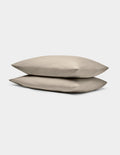 Two Cozy Earth Bamboo Jersey Pillowcases in beige are stacked atop one another against a plain white background.|Color:Driftwood
