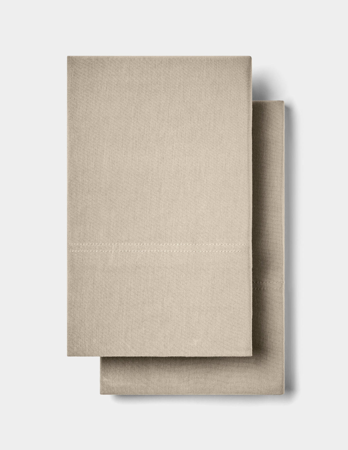 Two neatly folded Cozy Earth Bamboo Jersey Pillowcases are stacked together against a plain white background.|Color:Driftwood